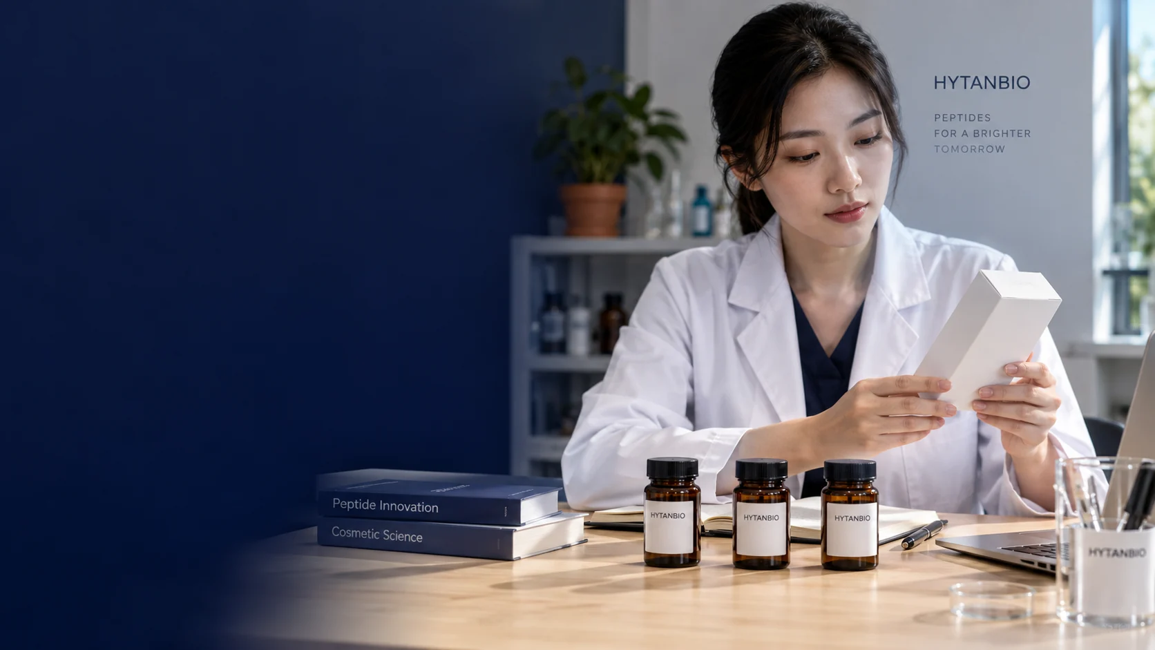 An East Asian ingredient specialist seated at a light oak laboratory desk, comparing a plain skincare package brief with three small upright amber ingredient jars; a terracotta plant pot far behind — illustrative development scene