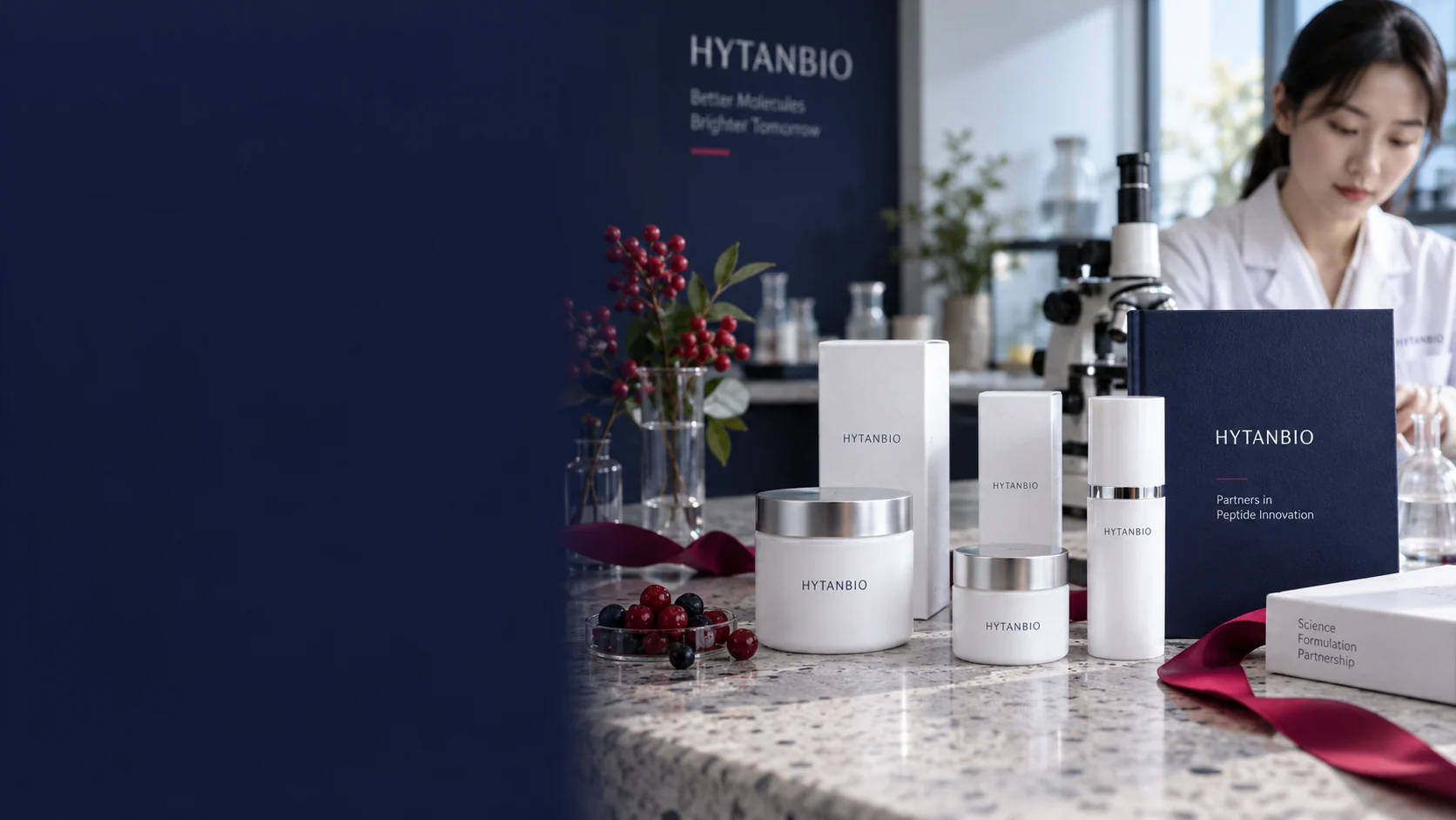 White cosmetic sample cartons, capped upright jars and a navy specimen folder arranged at differing depths on a pale terrazzo counter, berry ribbon accent and soft morning side light — illustrative development scene