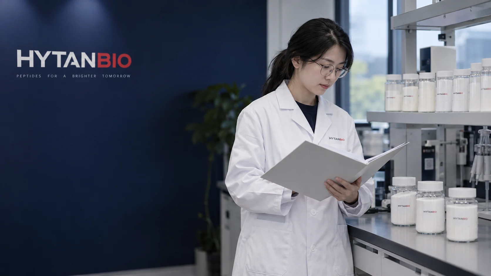 Random East Asian adult woman with a loose low ponytail and small round glasses, reviewing a plain documentation folder; straight capped amino-acid sample jars stand on a lab shelf in front of her — illustrative development scene