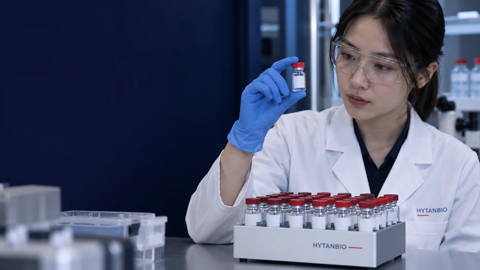 A compact rack of individually closed laboratory sample vials with non-legible neutral labels — illustrative development scene