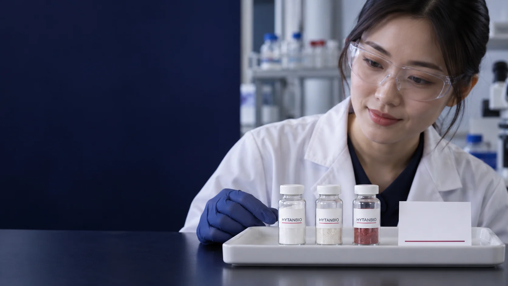 A white tray with three different upright ingredient sample vials and a blank reference card — illustrative development scene