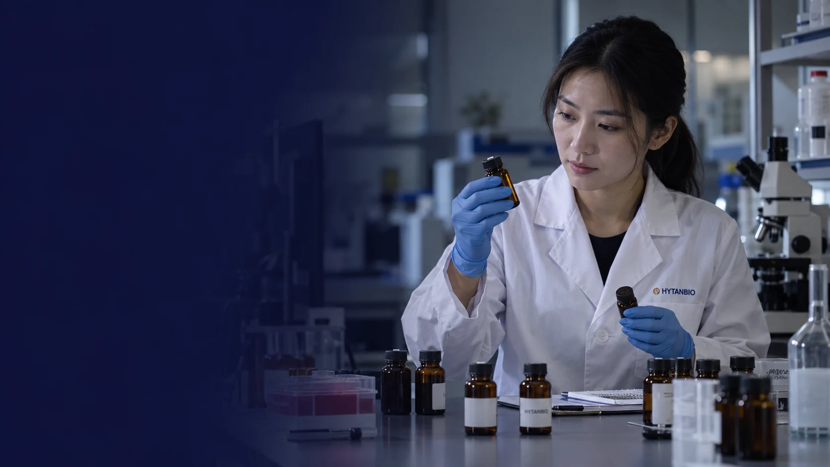 An East Asian scientist reviews different sample references at a quiet laboratory bench with amber bottles — illustrative development scene