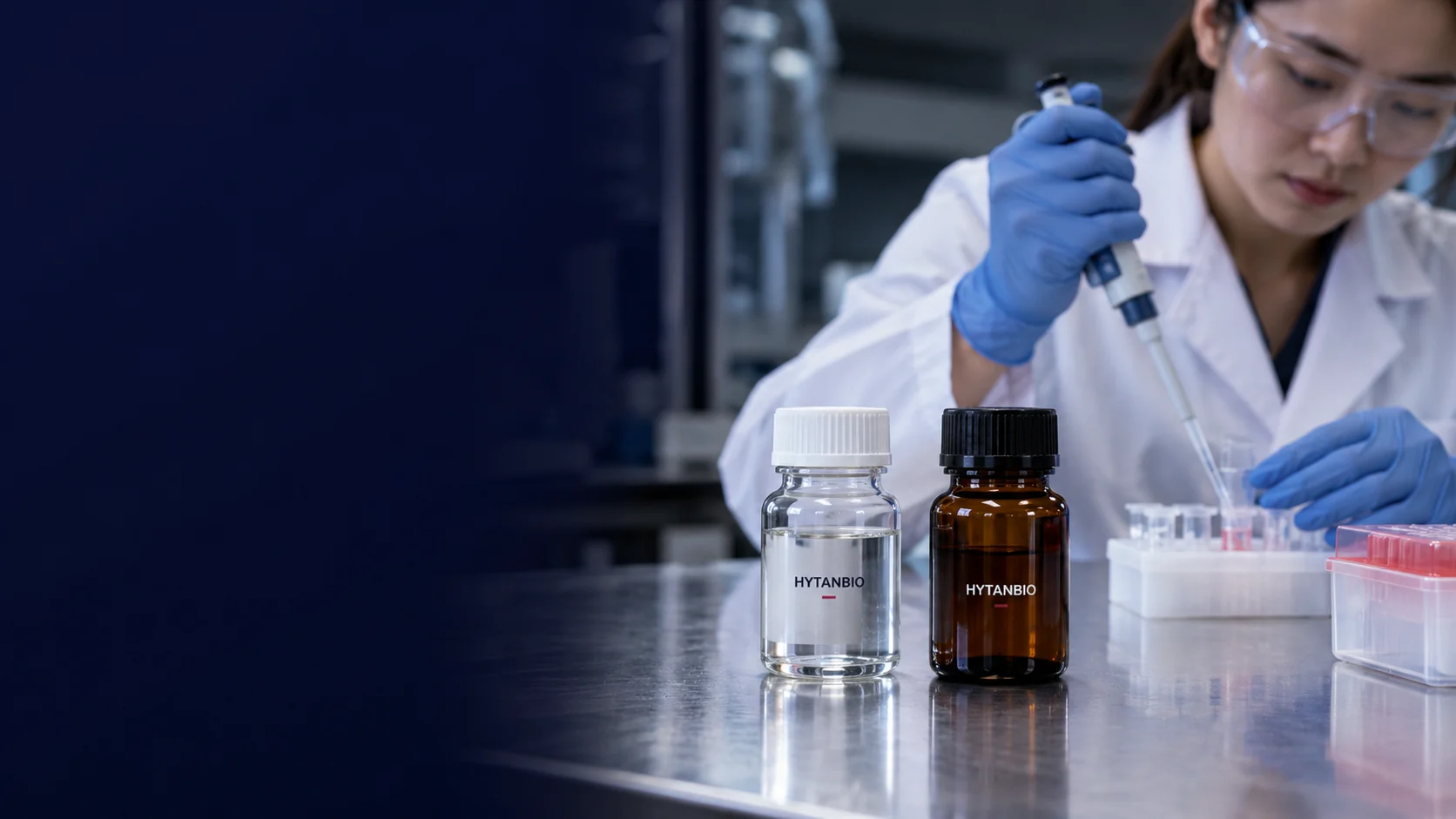 A clear capped sample bottle and an amber sample bottle stand separately on a clean steel bench — illustrative development scene