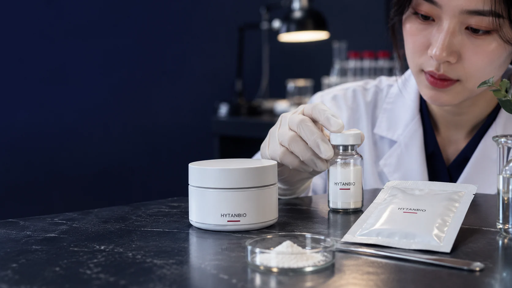 A closed cosmetic jar, film sachet and ingredient vial presented as separate development references — illustrative development scene