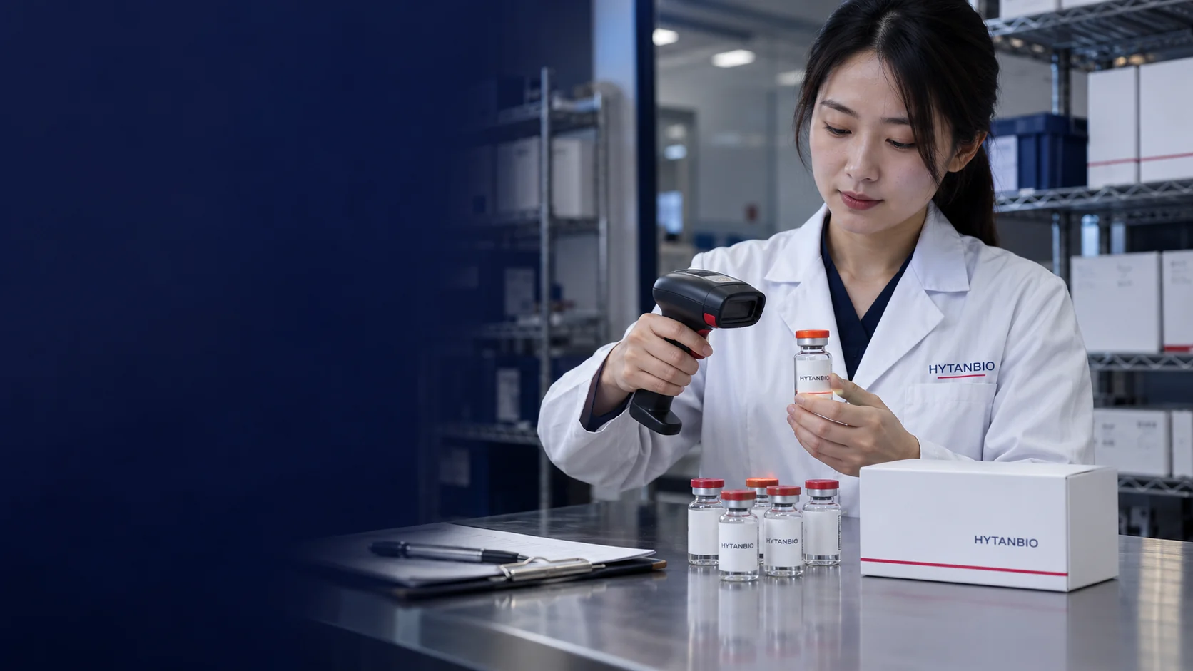 A handheld barcode reader beside upright sample vials and a white closed carton on a receiving desk — illustrative development scene